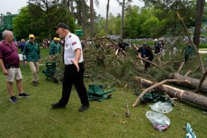 Storm causes interruption in Masters golf tournament as trees fall onto course.