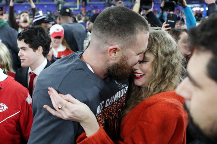 Taylor Swift and Travis Kelce share a kiss in celebration of Kansas City's advancement to the Super Bowl